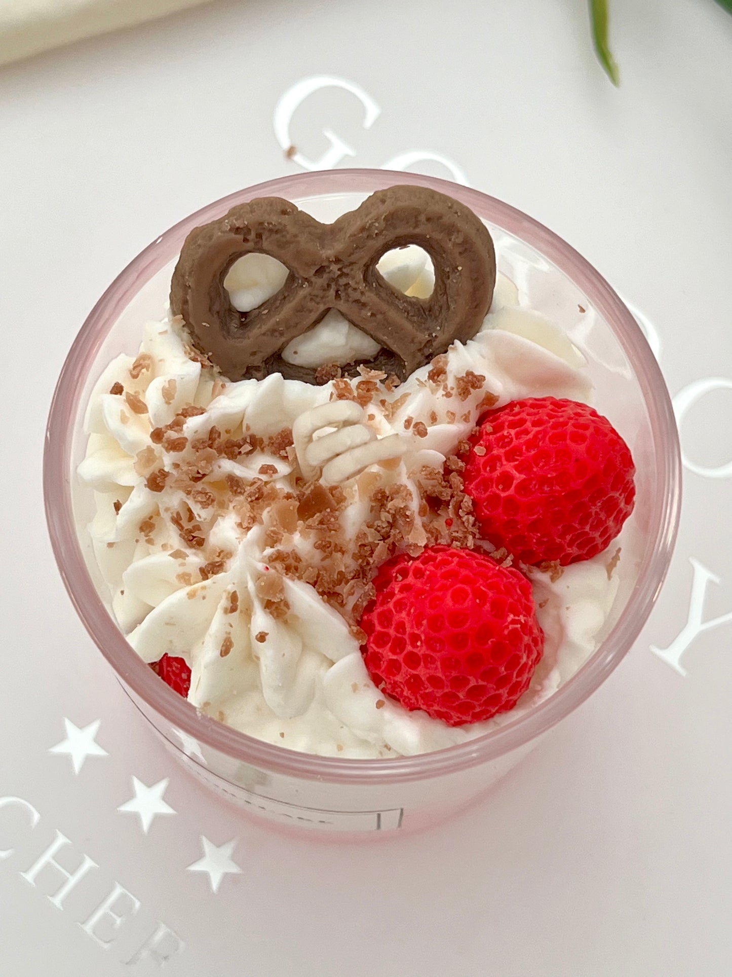 Close-up of handmade Strawberry Shortcake dessert candle.
